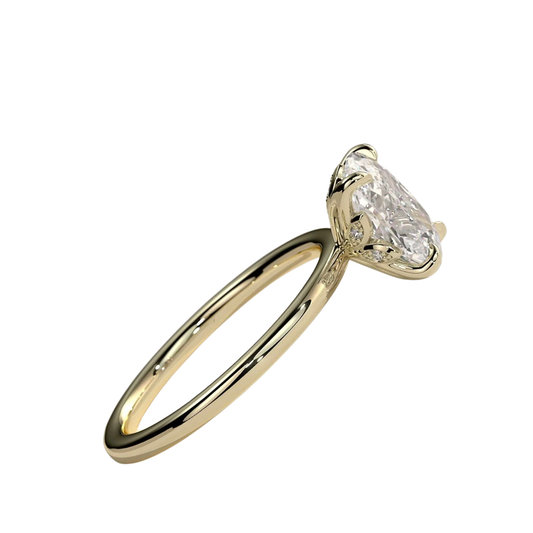 Luxury elongated cushion cut engagement ring featuring a brilliant claw-set solitaire center stone with an elegant petal gallery and delicate leaf accent details. Crafted in white gold with a nature-inspired design, available in lab-grown diamond or moissanite options for timeless elegance and everyday luxury.
