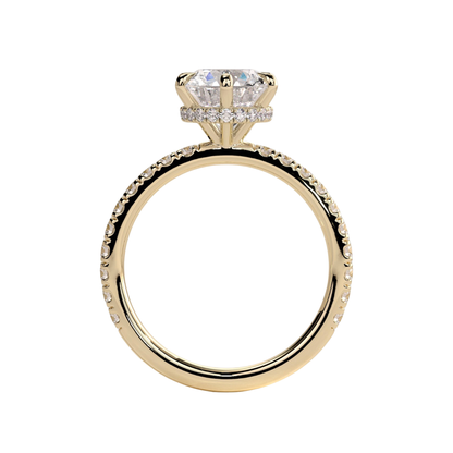 Luxury round claw solitaire engagement ring featuring a brilliant round-cut center stone secured in a refined claw setting with a sparkling wrap around hidden halo and pavé diamond band. Elegant timeless design crafted for exceptional brilliance and sophistication, available in white gold, yellow gold, rose gold, platinum, lab-grown diamond, or moissanite options.